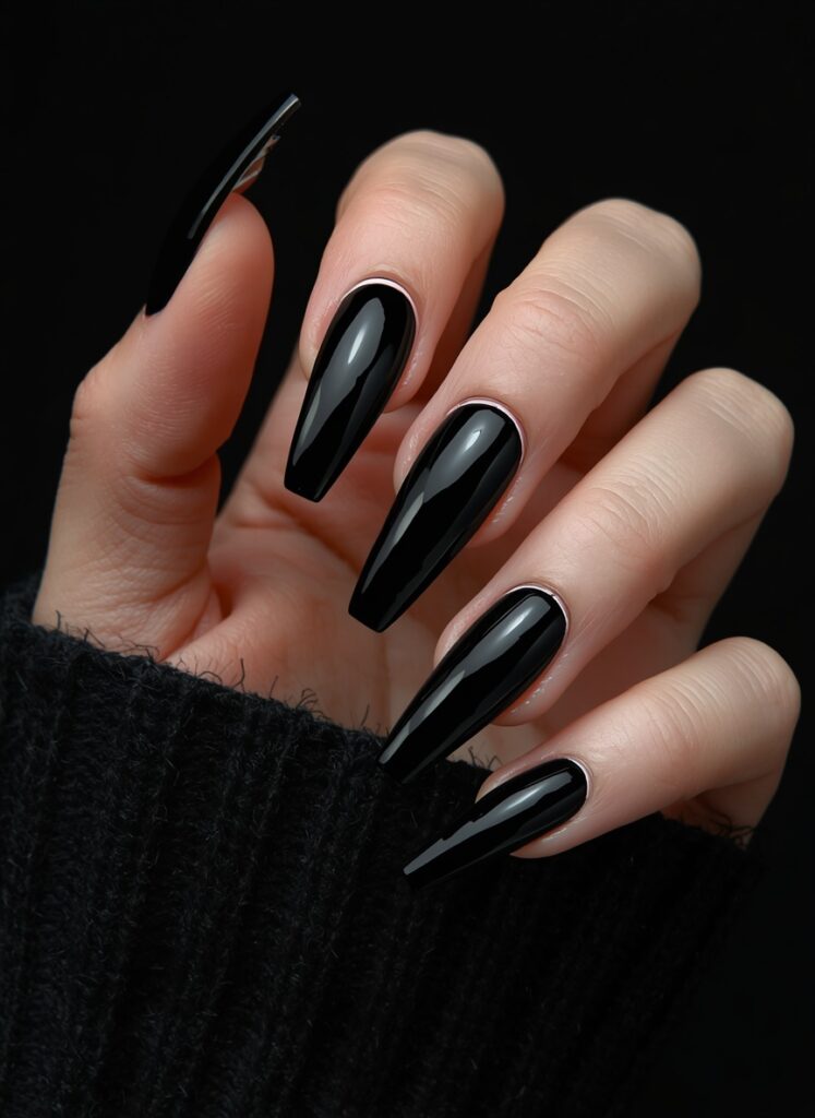 Long glossy black coffin nails with sleek gothic style and dramatic dark manicure design