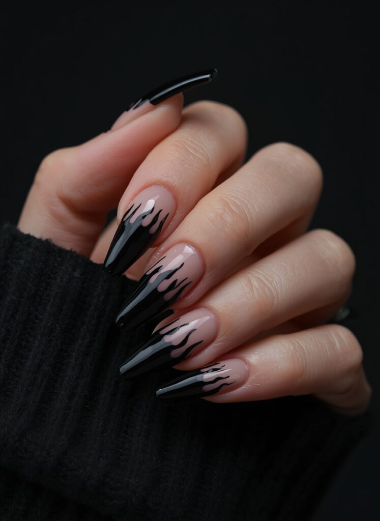 Black flame nails with glossy stiletto shape and dark gothic Halloween nail art design
